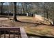 Large, fenced backyard with mature trees and a storage shed in a residential neighborhood at 2031 Lakewood Cir, Grayson, GA 30017