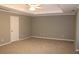 Large bedroom with neutral walls and carpet, featuring a tray ceiling with ceiling fan at 2031 Lakewood Cir, Grayson, GA 30017