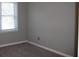 Bedroom with neutral walls and carpet, featuring a window with natural light at 2031 Lakewood Cir, Grayson, GA 30017