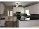 Well-lit kitchen with white cabinets, black granite counters, mosaic backsplash, and stainless steel appliances at 2031 Lakewood Cir, Grayson, GA 30017