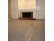 Cozy living room featuring a brick fireplace flanked by built-in shelves and cabinets at 2031 Lakewood Cir, Grayson, GA 30017