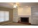 Comfortable living room with fireplace, built-in shelving, and large windows at 2031 Lakewood Cir, Grayson, GA 30017