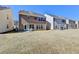 Back exterior view showcasing a well-maintained yard with a concrete patio and outdoor seating area at 2157 Staunton Dr, Duluth, GA 30096