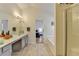 Bright bathroom featuring dual vanity, tiled floors, and a glass shower stall at 2157 Staunton Dr, Duluth, GA 30096