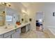 Bright bathroom featuring dual vanity, tiled floors, and a view to the bedroom at 2157 Staunton Dr, Duluth, GA 30096