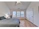 Bright bedroom featuring hardwood floors, a ceiling fan, and a large window with natural light at 2157 Staunton Dr, Duluth, GA 30096