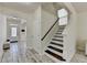 Hallway view showing the stairs, front door, and an opening leading to another room at 2157 Staunton Dr, Duluth, GA 30096