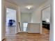 Hallway view featuring modern floors and doorways leading to an office and bedroom at 2157 Staunton Dr, Duluth, GA 30096