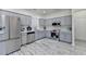 Kitchen with stainless steel appliances and updated cabinets and white wood patterned flooring at 2157 Staunton Dr, Duluth, GA 30096