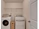 Functional laundry room with a washer, dryer, and shelving for storage at 2157 Staunton Dr, Duluth, GA 30096