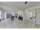 Open concept living room with view of the kitchen, stairs, and white wood patterned flooring at 2157 Staunton Dr, Duluth, GA 30096