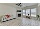 Bright living room featuring a fireplace, ceiling fan and light white wood patterned flooring at 2157 Staunton Dr, Duluth, GA 30096