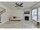 Living room featuring fireplace, ceiling fan, and stairs with white wood patterned flooring at 2157 Staunton Dr, Duluth, GA 30096