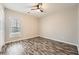 Cozy bedroom featuring wood-look floors, natural light, and a ceiling fan at 2985 Pilgrim Mill Rd, Cumming, GA 30041