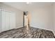 Bedroom with neutral walls, wood-look floors, and a double door closet for ample storage at 2985 Pilgrim Mill Rd, Cumming, GA 30041