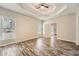 Large bedroom featuring tray ceiling, wood-look floors, and lots of light at 2985 Pilgrim Mill Rd, Cumming, GA 30041