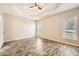 Expansive bedroom with elegant tray ceiling, natural light, and wood-look floors at 2985 Pilgrim Mill Rd, Cumming, GA 30041