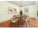 Staged dining room with hardwood flooring, a chandelier, and lots of natural light at 545 Spalding Dr, Atlanta, GA 30328