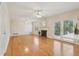 Bright living room featuring hardwood flooring, a fireplace, and glass doors to a patio at 545 Spalding Dr, Atlanta, GA 30328