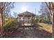 Charming wooden gazebo nestled in a landscaped backyard, ideal for outdoor relaxation and entertaining guests at 6798 Blackstone Pl # 12, Mableton, GA 30126