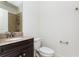 Clean bathroom featuring a dark wood vanity with granite countertop and shower with tile surround at 1199 Huff Nw Rd # 109, Atlanta, GA 30318