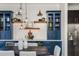 Beautiful dining area featuring navy cabinets with glass doors, open shelving, and stainless steel refrigerator at 1199 Huff Nw Rd # 109, Atlanta, GA 30318