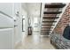 Bright entryway with tile floors, brick accent wall, and open staircase at 1199 Huff Nw Rd # 109, Atlanta, GA 30318