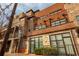 Multi-story brick building showing a mix of brick and stone with orange entry doors at 1199 Huff Nw Rd # 109, Atlanta, GA 30318