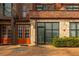View of the exterior of a brick building with orange doors and stone accents at 1199 Huff Nw Rd # 109, Atlanta, GA 30318