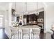 Kitchen with stainless steel appliances, dark cabinets, granite countertops, and island with barstool seating at 1199 Huff Nw Rd # 109, Atlanta, GA 30318