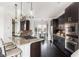 Modern kitchen with stainless steel appliances, dark cabinets and granite countertops, open to dining area at 1199 Huff Nw Rd # 109, Atlanta, GA 30318