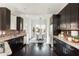 Modern kitchen with stainless steel appliances, dark cabinets, brick backsplash, and eat-in dining room at 1199 Huff Nw Rd # 109, Atlanta, GA 30318