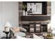 Living room fireplace with wooden mantle, decorative vases and abstract art on top of a sliding door at 1199 Huff Nw Rd # 109, Atlanta, GA 30318