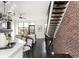 Bright living room with stairs, hardwood floors, brick wall, and a comfortable seating area at 1199 Huff Nw Rd # 109, Atlanta, GA 30318