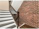Elegant staircase featuring brick accent wall and modern railing at 1199 Huff Nw Rd # 109, Atlanta, GA 30318