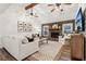 Vaulted living room featuring a stone fireplace, ceiling fans, and ample seating at 122 Dials Dr, Woodstock, GA 30188