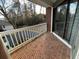 Cozy balcony features brick flooring, a white railing, and neighborhood views at 1376 Keys Lake Ne Dr, Brookhaven, GA 30319