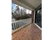Cozy balcony features brick flooring, a white railing, and neighborhood views at 1376 Keys Lake Ne Dr, Brookhaven, GA 30319