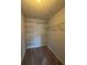 A large walk-in closet has fully adjustable shelves to maximize storage potential at 1376 Keys Lake Ne Dr, Brookhaven, GA 30319