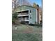 Three-story apartment building features balconies and verdant landscaping, enhancing its curb appeal at 1376 Keys Lake Ne Dr, Brookhaven, GA 30319