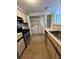 Kitchen with a stainless steel range, cabinets, and washer and dryer at 1376 Keys Lake Ne Dr, Brookhaven, GA 30319