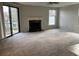 A bright living room with a sliding glass door to the outside and a cozy fireplace at 1376 Keys Lake Ne Dr, Brookhaven, GA 30319