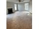 Spacious living room featuring a fireplace, two windows, and a ceiling fan at 1376 Keys Lake Ne Dr, Brookhaven, GA 30319