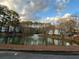 Picturesque pond with fountain surrounded by lush trees provides a serene environment for the community at 1376 Keys Lake Ne Dr, Brookhaven, GA 30319