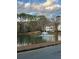 Scenic view of a pond with a fountain is surrounded by trees, enhancing the community's appeal at 1376 Keys Lake Ne Dr, Brookhaven, GA 30319