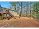 Extensive backyard showcases a deck and mature trees, ideal for relaxing at 8640 Embrey Dr, Jonesboro, GA 30236