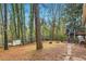 Spacious backyard with mature trees and a deck, perfect for outdoor gatherings at 8640 Embrey Dr, Jonesboro, GA 30236