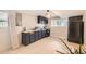 Basement kitchenette with dark blue cabinets and a black refrigerator at 8640 Embrey Dr, Jonesboro, GA 30236