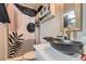 Modern bathroom featuring a vessel sink, stylish shower curtain, and decorative mirror at 8640 Embrey Dr, Jonesboro, GA 30236