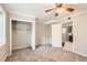 View of a bedroom featuring a ceiling fan, closet, and carpeted floor at 8640 Embrey Dr, Jonesboro, GA 30236